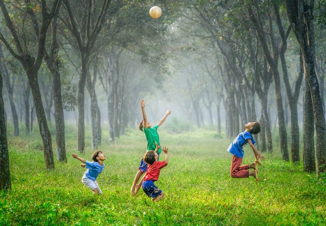 Kids exercising with a ball having fun