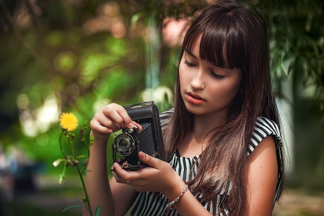 Young photographer taking flower picture